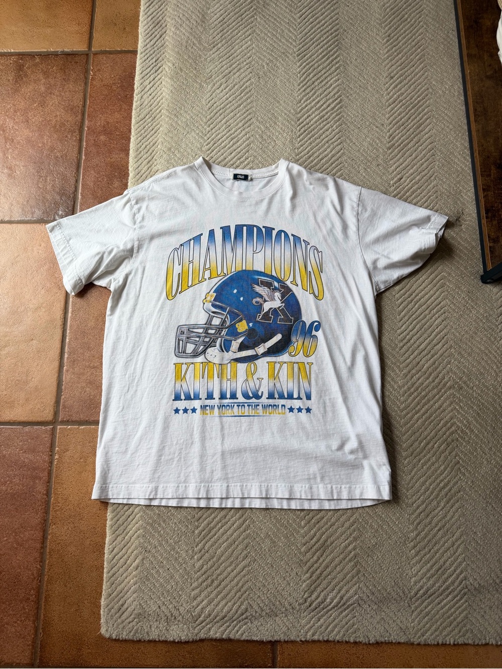Kith White Graphic 'Champions' Tee with Blue & Yellow Helmet Print